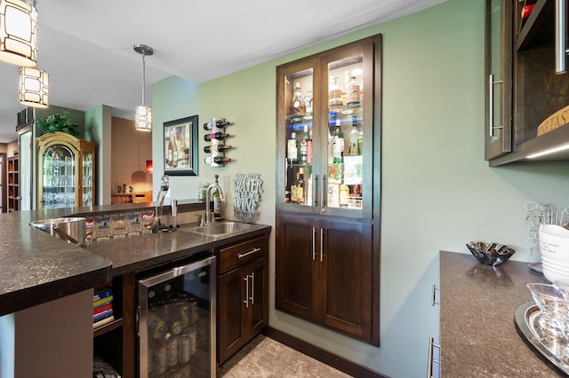 bar with hanging light fixtures, wine cooler, a sink, and wet bar