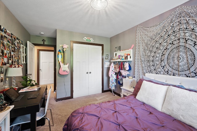 carpeted bedroom featuring a textured ceiling, a closet, and baseboards