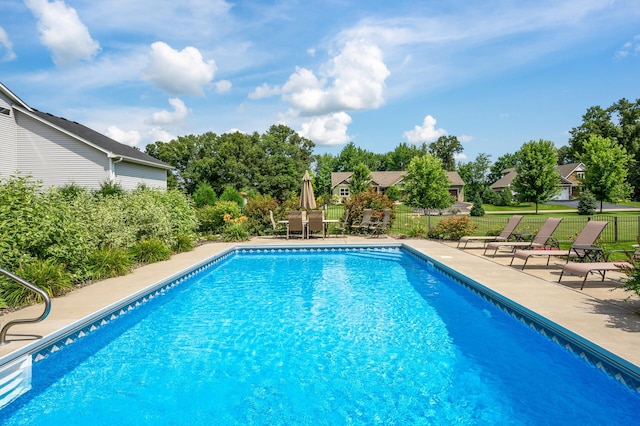 view of pool with fence, a fenced in pool, and a patio