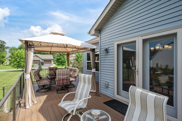 deck with a gazebo and outdoor dining space