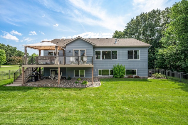 back of property with a fenced backyard, a lawn, a gazebo, and stairs