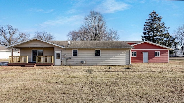 back of property with a wooden deck, a yard, and an outdoor structure