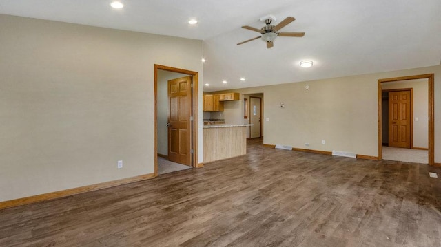 unfurnished living room with wood-type flooring, lofted ceiling, and ceiling fan