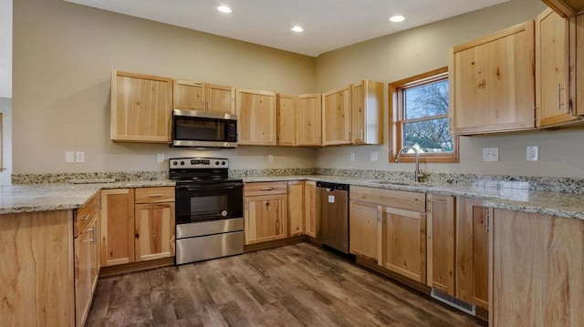 kitchen featuring sink, light brown cabinets, dark hardwood / wood-style floors, and appliances with stainless steel finishes