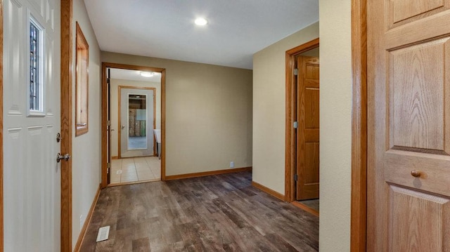 hallway with dark hardwood / wood-style floors