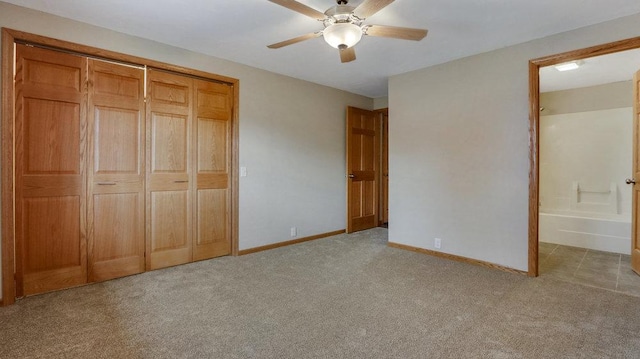 unfurnished bedroom with ceiling fan, connected bathroom, light carpet, and a closet