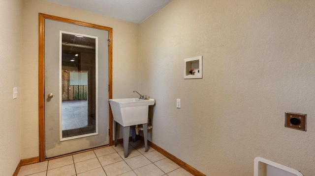 clothes washing area featuring washer hookup, light tile patterned floors, and hookup for an electric dryer