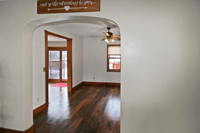 empty room featuring dark wood-type flooring and ceiling fan