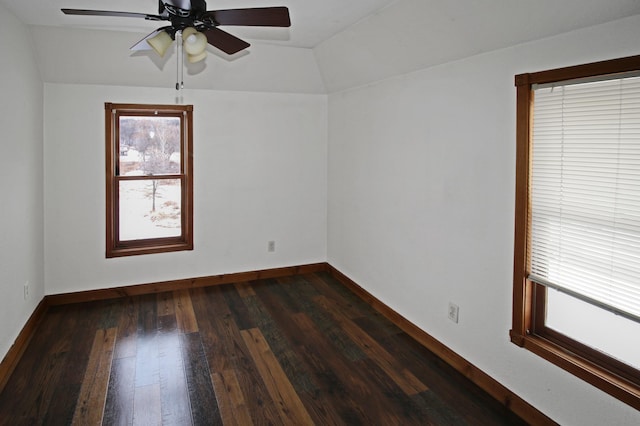 spare room with vaulted ceiling, dark hardwood / wood-style floors, and ceiling fan