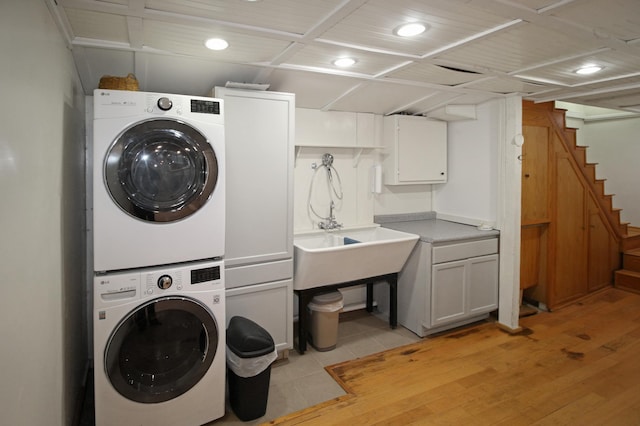 washroom with stacked washing maching and dryer