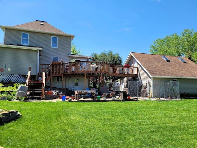 rear view of property featuring a wooden deck and a yard