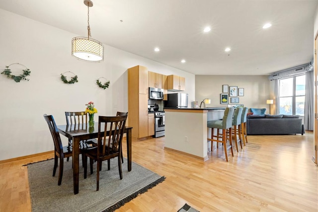 dining room featuring recessed lighting, light wood-style floors, and baseboards