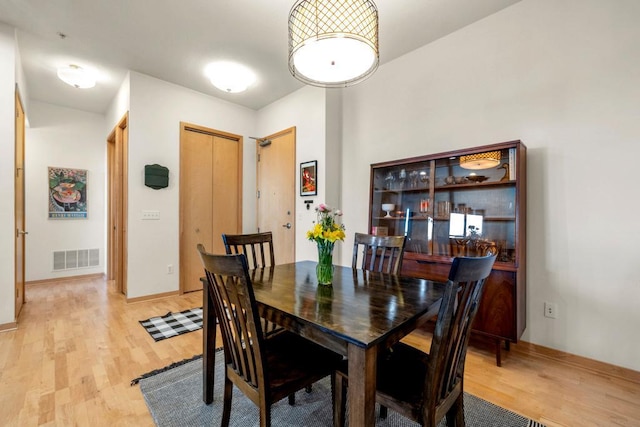 dining room with visible vents and light wood-style flooring