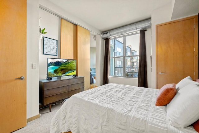 bedroom featuring baseboards and light carpet