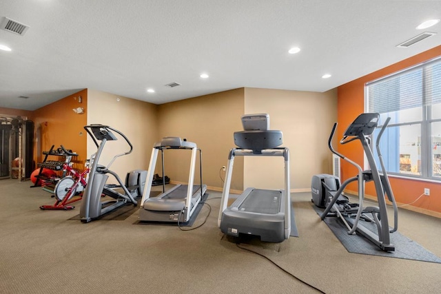 workout area with recessed lighting, visible vents, baseboards, and a textured ceiling