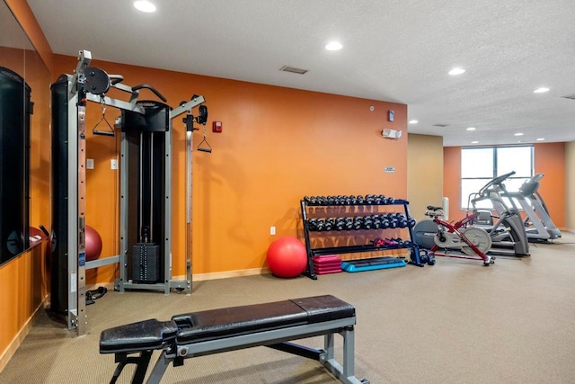 gym featuring visible vents, recessed lighting, a textured ceiling, and baseboards