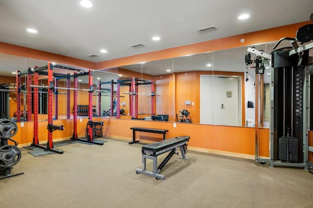 exercise room with recessed lighting, visible vents, and baseboards