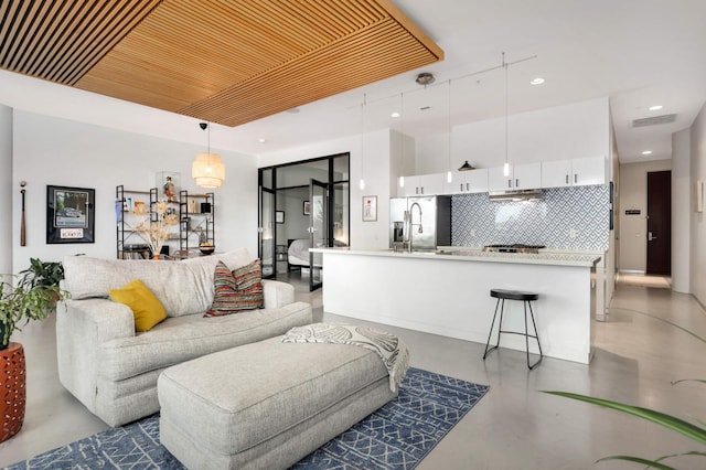 living room with wooden ceiling, finished concrete floors, visible vents, and recessed lighting