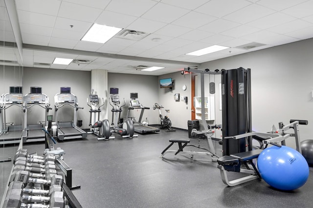 exercise room featuring a paneled ceiling and visible vents