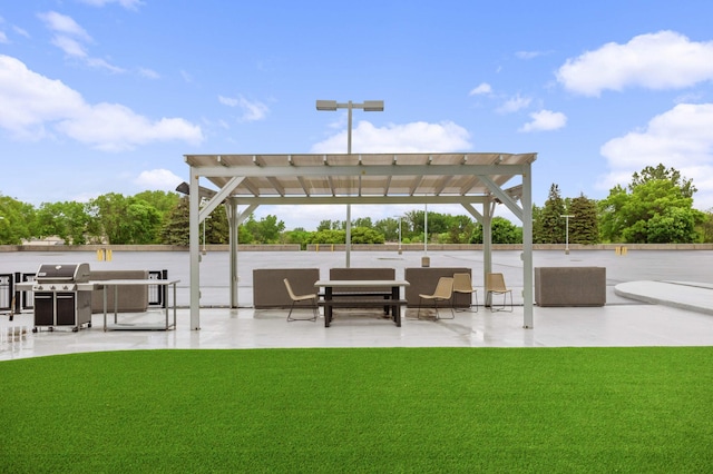 view of patio with area for grilling and a pergola