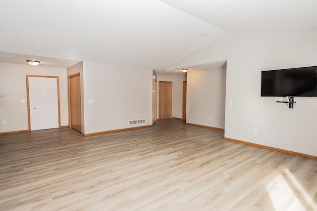 unfurnished living room featuring vaulted ceiling and light wood-type flooring