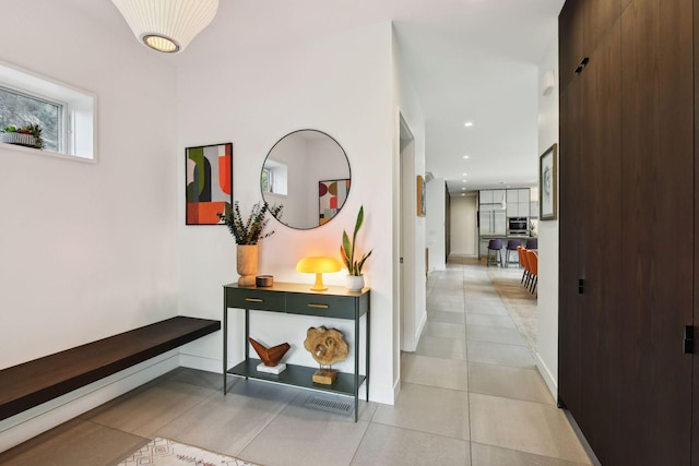 hallway with light tile patterned flooring