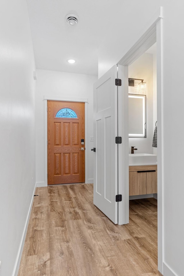 425 8th St Unit 23, New Richmond, WI 54017 - entrance foyer with light wood-style flooring and baseboards