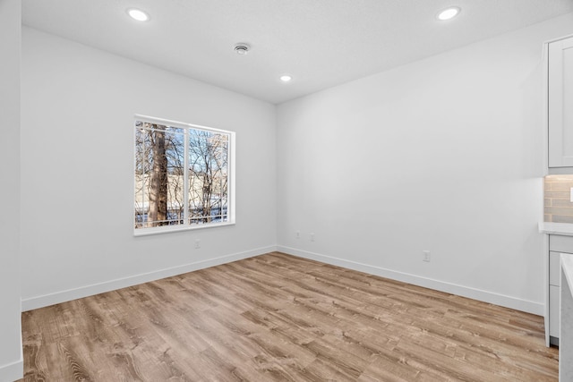 425 8th St Unit 23, New Richmond, WI 54017 - unfurnished room with light wood-style floors, recessed lighting, and baseboards