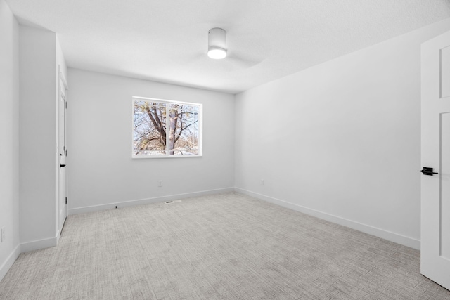 425 8th St Unit 23, New Richmond, WI 54017 - empty room featuring a ceiling fan, light colored carpet, and baseboards