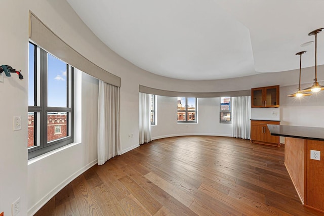 929 Portland Ave Unit 406, Minneapolis, MN 55404 - unfurnished living room with dark wood-style floors and baseboards