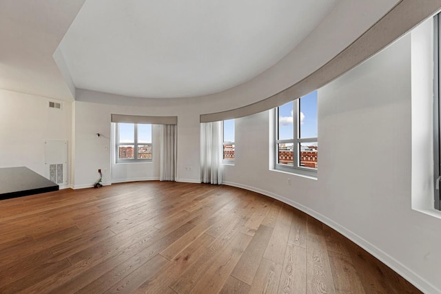 929 Portland Ave Unit 406, Minneapolis, MN 55404 - unfurnished living room featuring hardwood / wood-style floors and baseboards