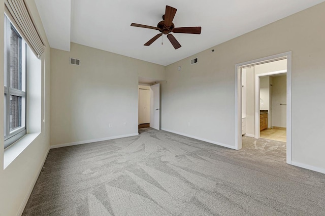 929 Portland Ave Unit 406, Minneapolis, MN 55404 - unfurnished bedroom with carpet, baseboards, connected bathroom, and ceiling fan