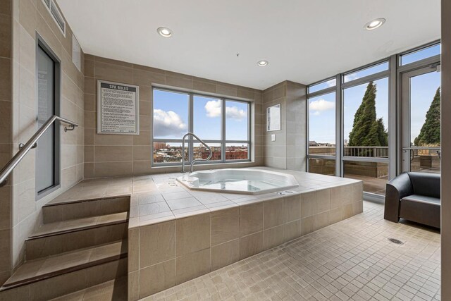 929 Portland Ave Unit 406, Minneapolis, MN 55404 - bathroom with healthy amount of natural light, recessed lighting, tile patterned flooring, and a relaxing tiled tub
