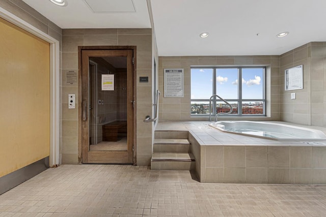 929 Portland Ave Unit 406, Minneapolis, MN 55404 - bathroom with tile walls, a garden tub, recessed lighting, tile patterned flooring, and a shower with shower door