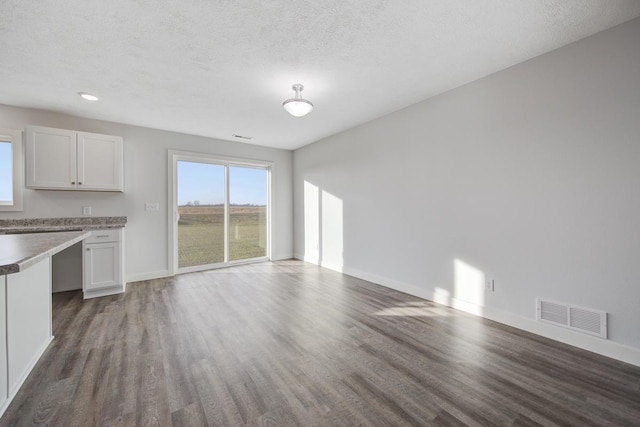 interior space featuring hardwood / wood-style flooring and a textured ceiling