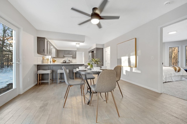 dining room featuring ceiling fan and light wood-type flooring