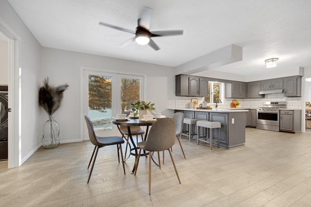 dining room with ceiling fan and light hardwood / wood-style floors