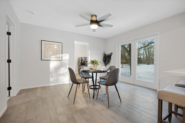 dining room with ceiling fan and light hardwood / wood-style flooring