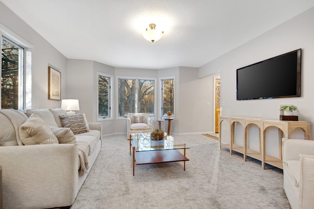 carpeted living room featuring plenty of natural light