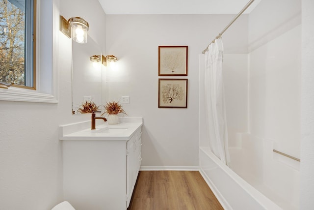 bathroom featuring hardwood / wood-style flooring, shower / tub combo with curtain, and vanity