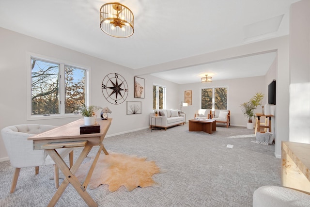 carpeted dining area with a healthy amount of sunlight and a chandelier