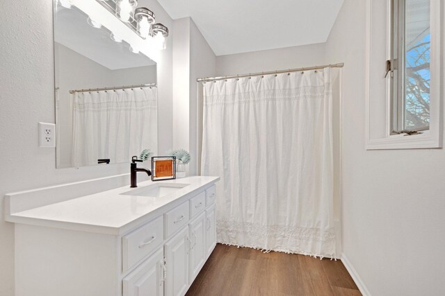 bathroom with hardwood / wood-style flooring and vanity