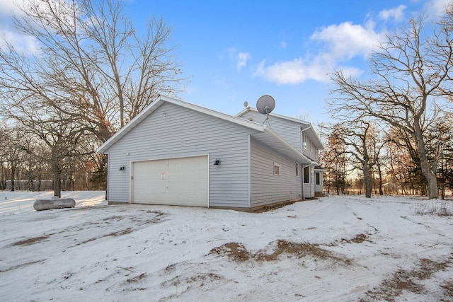 snow covered property featuring a garage