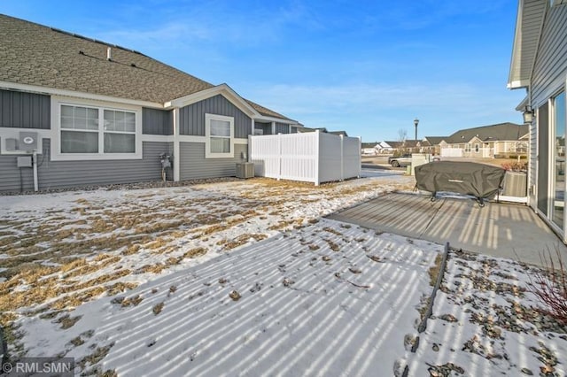 snow covered deck featuring central AC