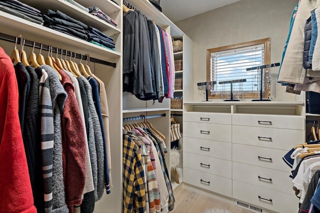 spacious closet with light wood-style floors and visible vents