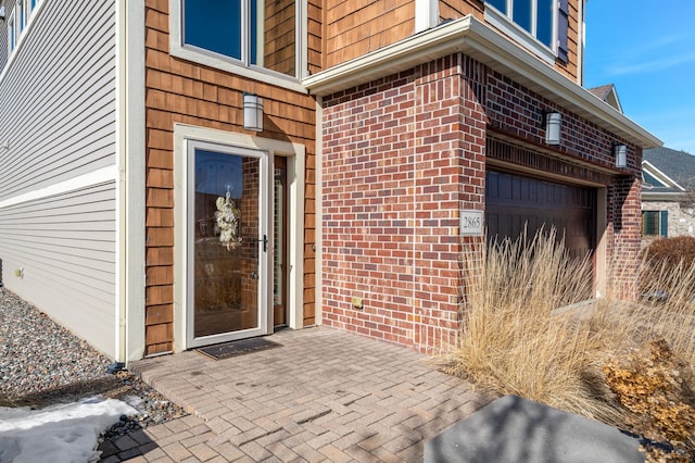 property entrance with brick siding