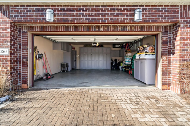 garage with decorative driveway