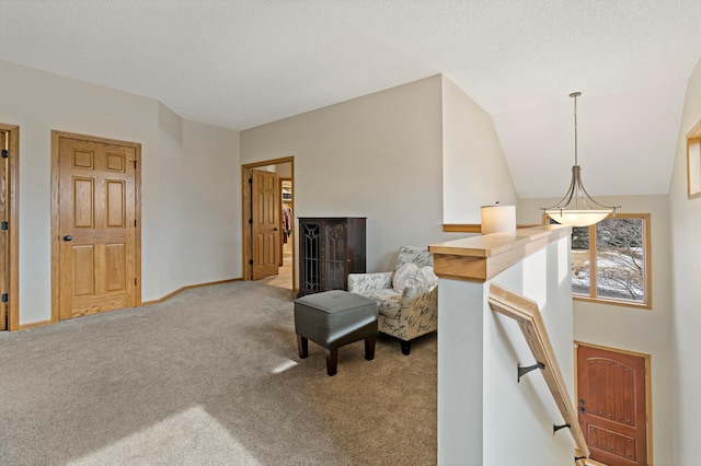 living area featuring baseboards, lofted ceiling, an upstairs landing, a textured ceiling, and carpet flooring