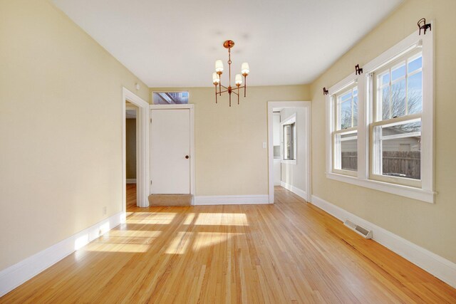 5421 30th Ave S, Minneapolis, MN 55417 - unfurnished room with an inviting chandelier and light hardwood / wood-style floors