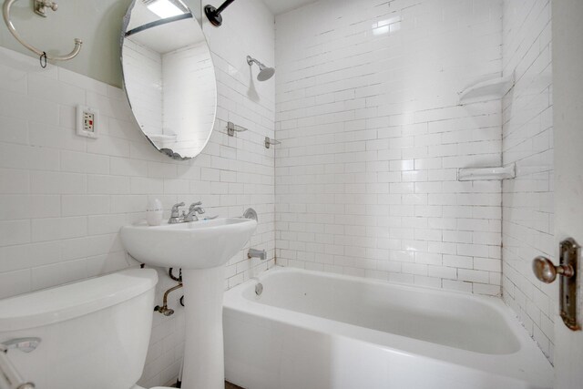 5421 30th Ave S, Minneapolis, MN 55417 - bathroom featuring tiled shower / bath, toilet, and tile walls